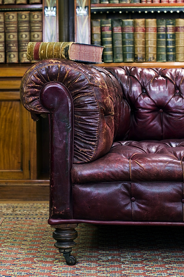 Retro sitting room with leather couch with book on it
